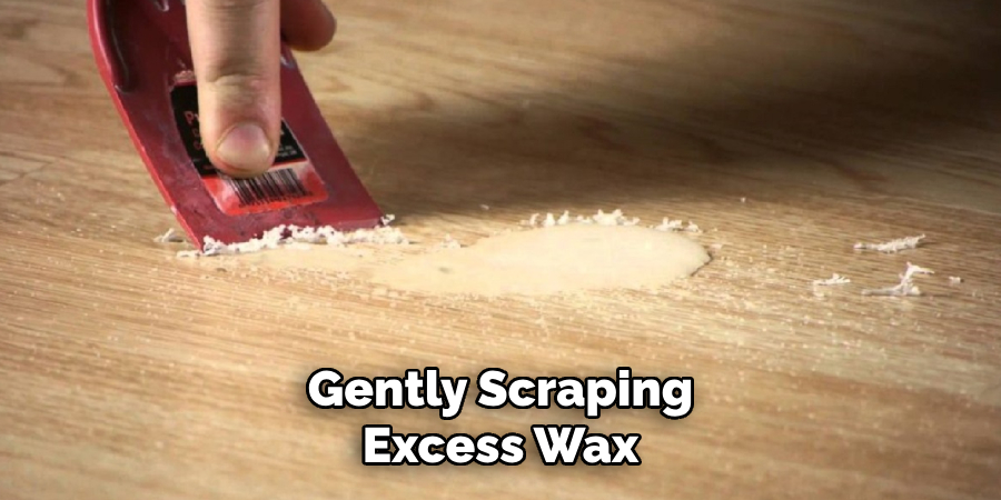 Gently Scraping Excess Wax