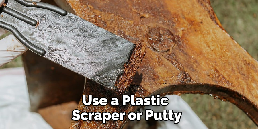 Use a Plastic Scraper or Putty