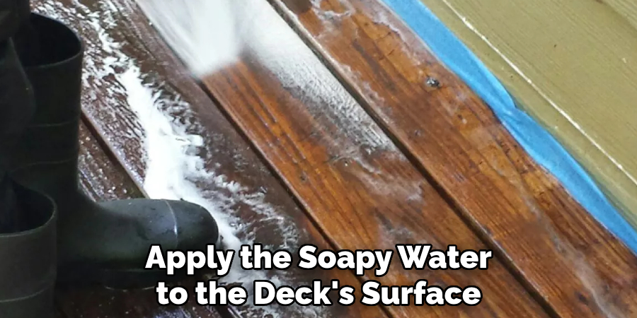 Apply the Soapy Water to the Deck's Surface