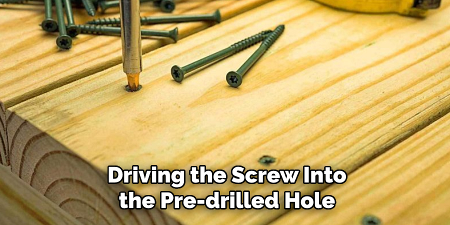 Driving the Screw Into the Pre-drilled Hole