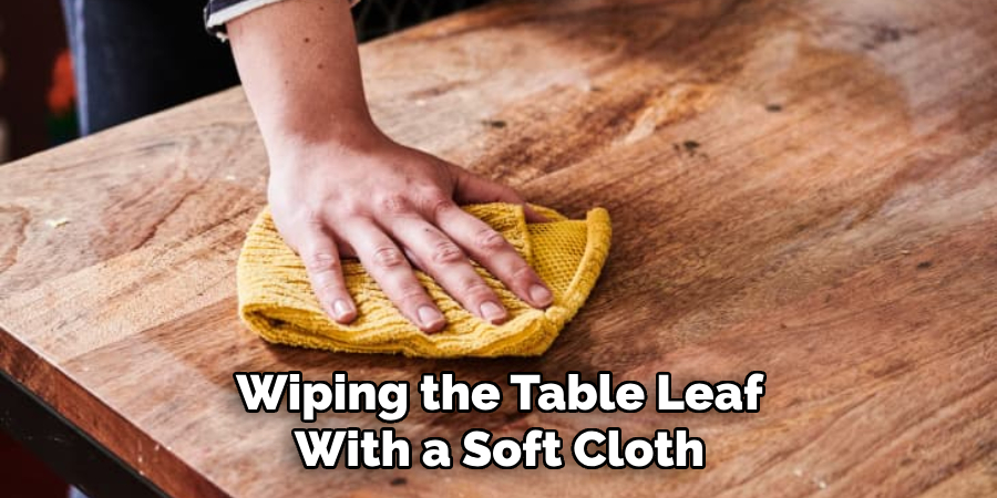 Wiping the Table Leaf With a Soft Cloth