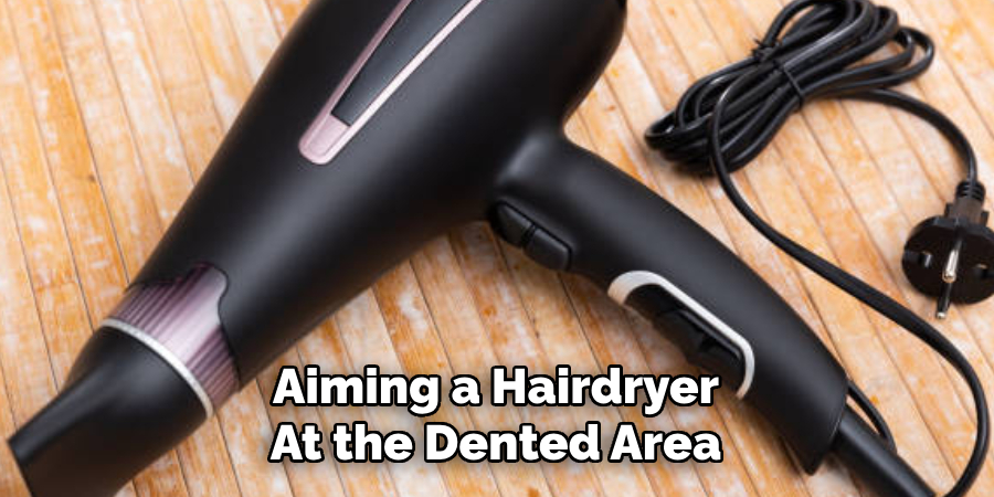 Aiming a Hairdryer At the Dented Area