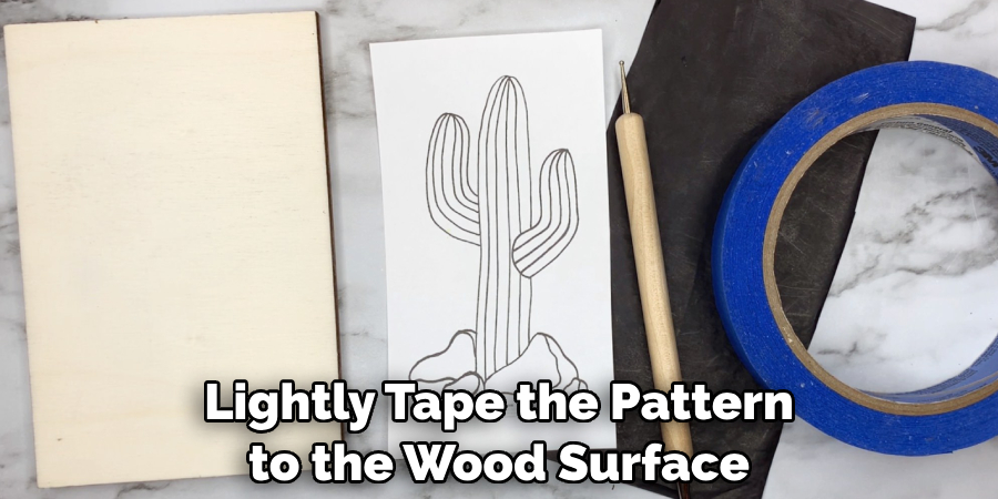 Lightly Tape the Pattern to the Wood Surface