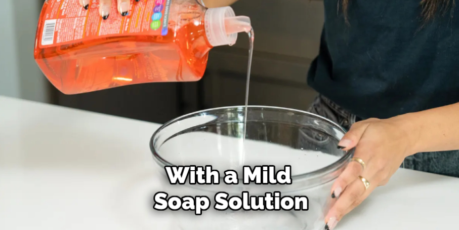 With a Mild Soap Solution