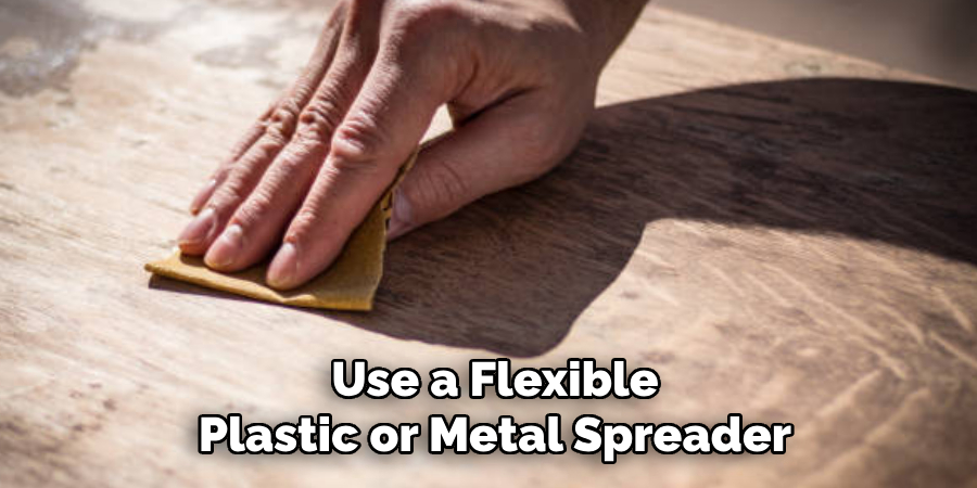 Use a Flexible Plastic or Metal Spreader