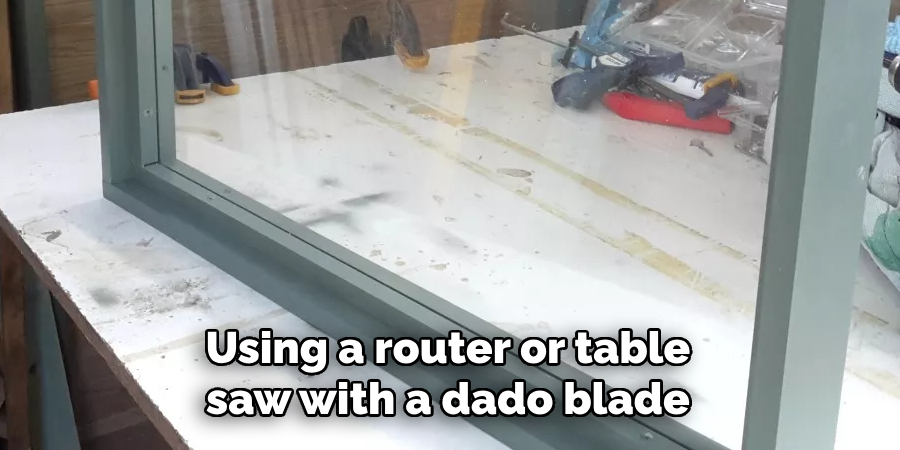 Using a router or table saw with a dado blade