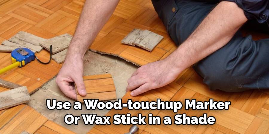 Use a Wood-touchup Marker
Or Wax Stick in a Shade